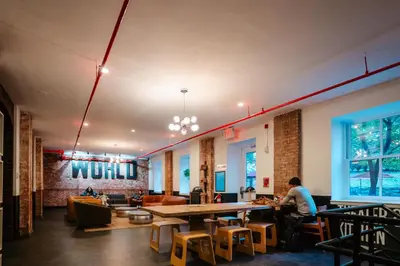 a restaurant with a large wooden table and chairs at HI New York City Hostel in New York