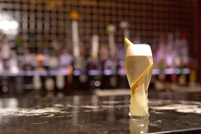 a glass of beer sitting on top of a table at Hyatt Centric Wall Street New York in New York
