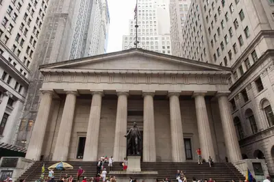 a building with a statue in the middle of a city at Hyatt Centric Wall Street New York in New York