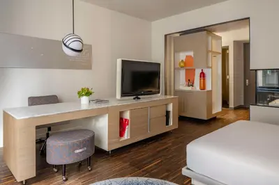 a room with a desk with a television and a bed at Hyatt Centric Wall Street New York in New York