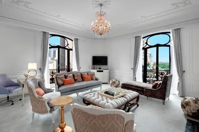 a living room filled with furniture and a chandelier at The St. Regis New York in New York
