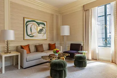 a living room with a couch and a table and chairs at The St. Regis New York in New York