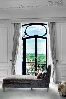 a room with a couch and a large window at The St. Regis New York in New York