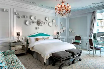 a bedroom with a bed and a chandelier at The St. Regis New York in New York