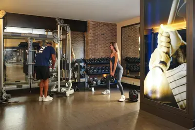 a man and a woman standing in a gym at InterContinental New York Times Square by IHG in New York