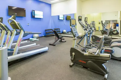 a gym with several tread machines in a room at Tioga Downs Casino and Resort in Nichols