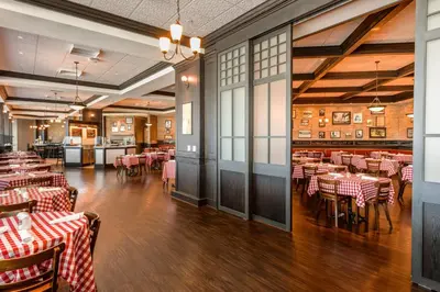 a restaurant with red and white tables and chairs at Tioga Downs Casino and Resort in Nichols