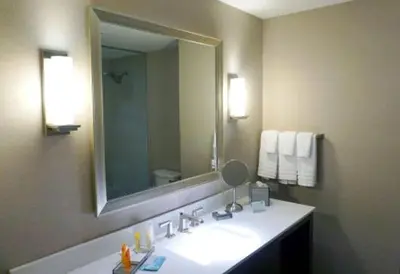 a bathroom with a sink and a large mirror at Tioga Downs Casino and Resort in Nichols