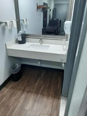 a bathroom with a sink and a mirror at Hillside Motel Glen Mills in Glen Mills