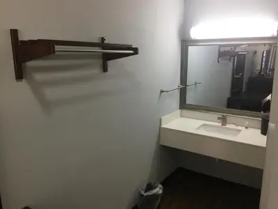 a bathroom with a sink and a mirror at Hillside Motel Glen Mills in Glen Mills