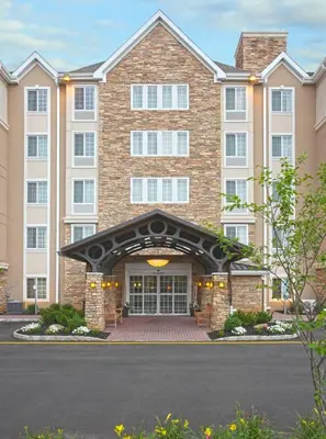 a large brick building with a large entrance at Staybridge Suites North Brunswick by IHG in North Brunswick