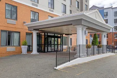 a entrance to a building with a metal gate at Country Inn & Suites by Radisson, Staten Island in Staten Island