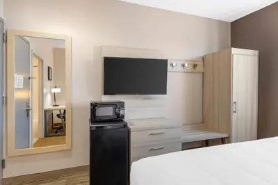 a hotel room with a tv and a bed at Country Inn & Suites by Radisson, Staten Island in Staten Island