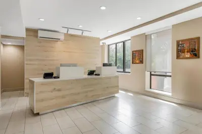 a lobby with a reception desk in a building at Country Inn & Suites by Radisson, Staten Island in Staten Island