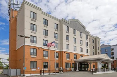 a building with an american flag in front of it at Country Inn & Suites by Radisson, Staten Island in Staten Island