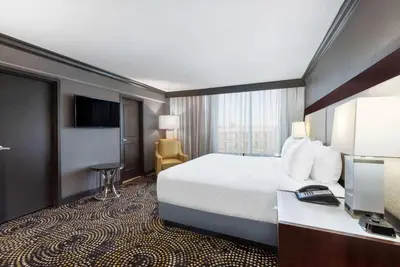 a hotel room with a bed and a television at Wyndham Lancaster Resort and Convention Center in Lancaster