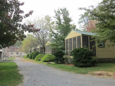 a house on a street next to a road at Appalachian Camping Resort Cottage 1 in Shartlesville