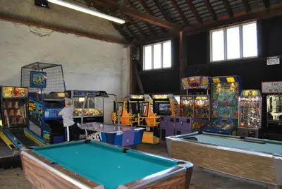 a room with several arcade games and pool tables at Robin Hill Camping Resort One-Bedroom Cottage 8 in Lenhartsville