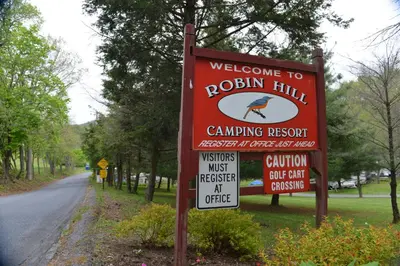 a sign for a rockin hill camping resort on a road at Robin Hill Camping Resort Premium Cottage 9 in Lenhartsville