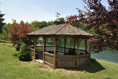 a gazebo with a cross on top in a park at Robin Hill Camping Resort Deluxe Cottage 13 in Lenhartsville