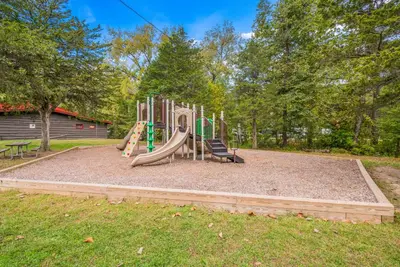 a playground with a slide in a park at Rondout Valley Camping Resort Deluxe Park Model 11 in Accord