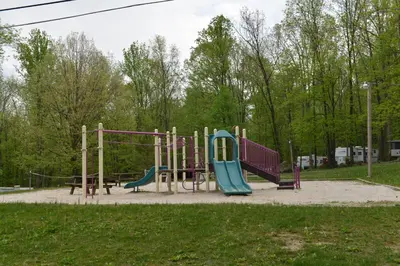 a playground with a slide in a park at Sun Valley Campground Cottage 4 in Maple Grove Park