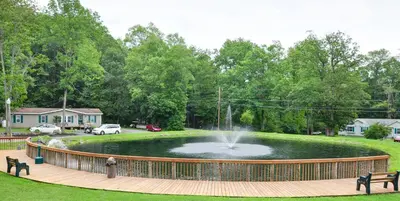 a pond with a fountain in the middle of a park at Sun Valley Campground Cottage 6 in Maple Grove Park