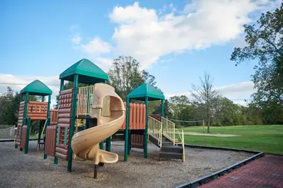 a playground with a slide in a park at Circle M Camping Resort Yurt in Lancaster