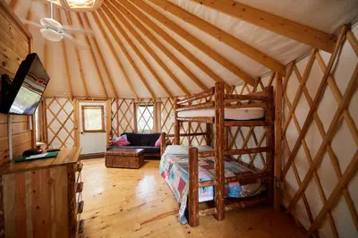 a room with a bed and a couch in a yurt at Circle M Camping Resort Yurt in Lancaster