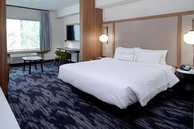 a hotel room with a large bed and a desk at Fairfield Inn & Suites by Marriott Allentown West in Breinigsville