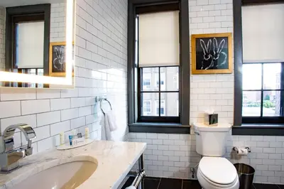 a bathroom with a toilet and a sink and windows at Fairfield Inn & Suites by Marriott Philadelphia Downtown/Center City in Philadelphia