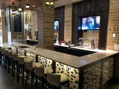 a bar in a restaurant with a row of bar stools at Fairfield Inn & Suites by Marriott Philadelphia Downtown/Center City in Philadelphia