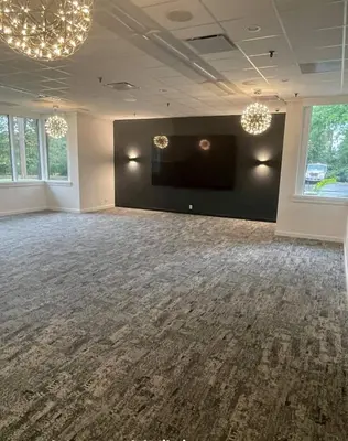 a large room with a flat screen tv on a wall at Ramada by Wyndham Newark/Wilmington in Newark