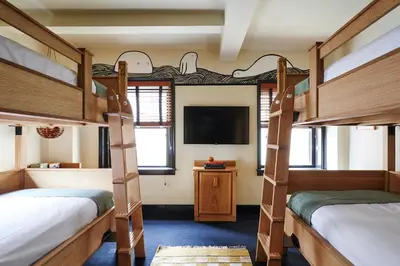 a room with two bunk beds and a flat screen tv at Freehand New York in New York