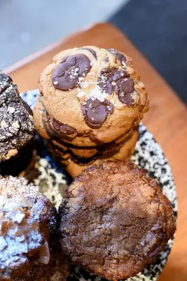 a pile of cookies on a plate on a table at Freehand New York in New York