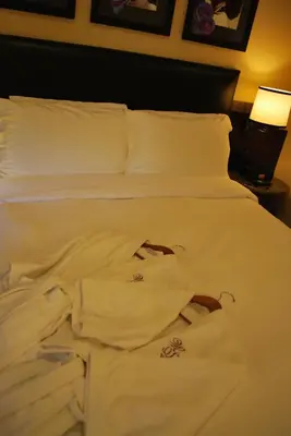 a bed with white sheets and a shirt on it at Washington Square Hotel in New York