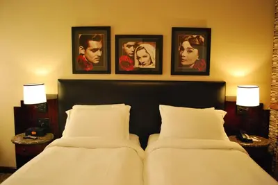 two beds in a hotel room with pictures on the wall at Washington Square Hotel in New York