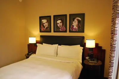 a bedroom with a bed with four pictures on the wall at Washington Square Hotel in New York