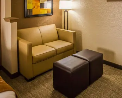 a chair and stool in a hotel room at Quality Suites NYC Gateway in North Bergen