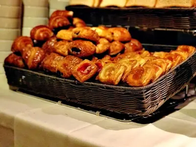 a bunch of donuts in a basket on a table at Sanctuary Hotel New York in New York