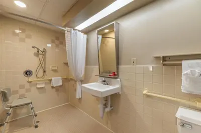a bathroom with a sink and a mirror at SureStay Hotel by Best Western East Brunswick in East Brunswick