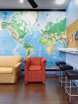 a large mural of a world on a wall at Central Park West Hostel in New York