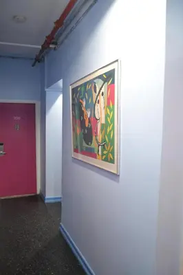 a painting hanging on a wall in a hallway at Central Park West Hostel in New York