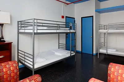a room with two bunk beds and a chair at Central Park West Hostel in New York