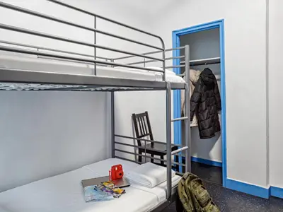 a bunk bed with a chair in a room at Central Park West Hostel in New York