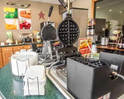 a kitchen counter with a mixer and dishes on it at Quality Inn New Columbia-Lewisburg in New Columbia