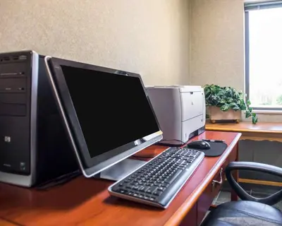 a desk with a computer and a monitor and a keyboard at Quality Inn New Columbia-Lewisburg in New Columbia