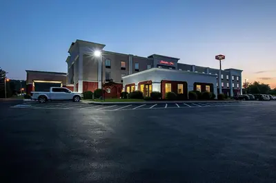 a white truck parked in a parking lot in front of a building at Hampton Inn Pine Grove in Pine Grove