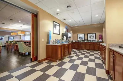 a waiting room with a counter and a restaurant at Hampton Inn Pine Grove in Pine Grove