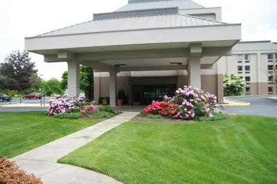 a gazebo with flowers in front of a building at Hampton Inn Downingtown/Exton in Exton